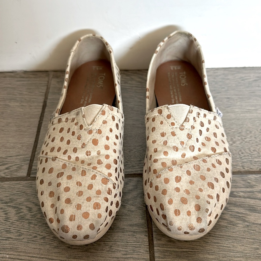 Tom’s slip on shoes. White with gold polka dots